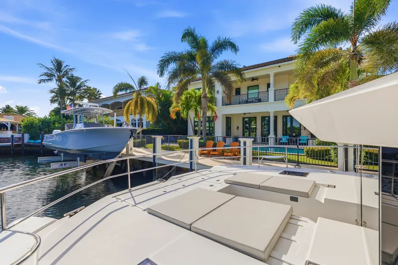 Better Now Yacht Photos Pics Luxurious Leopard 46 Powercat yacht docked near a waterfront villa, 2023 model.