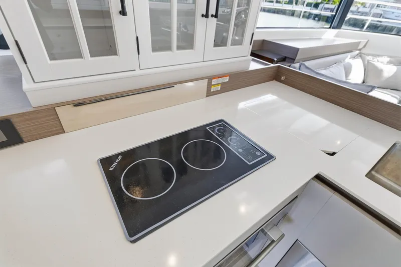 Better Now Yacht Photos Pics Modern kitchen on 2023 Leopard 46 Powercat with sleek induction cooktop and cabinetry.