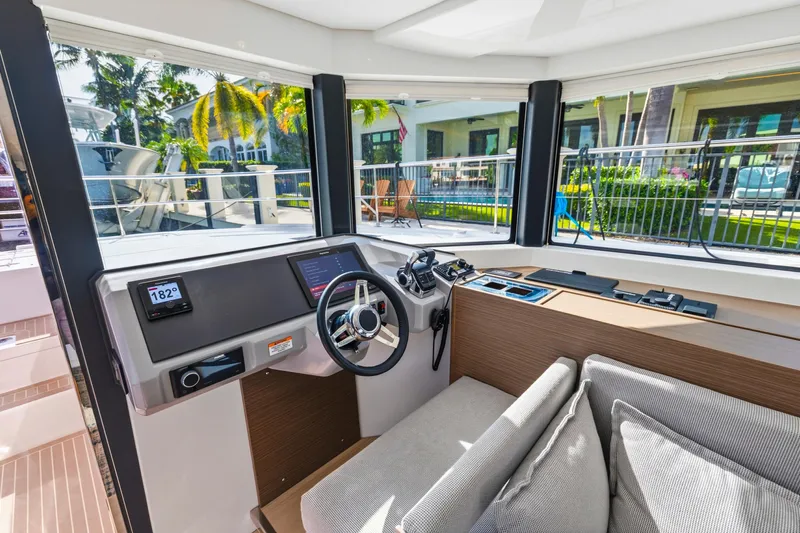 Better Now Yacht Photos Pics Interior helm of 2023 Leopard 46 Powercat with modern controls and panoramic windows.