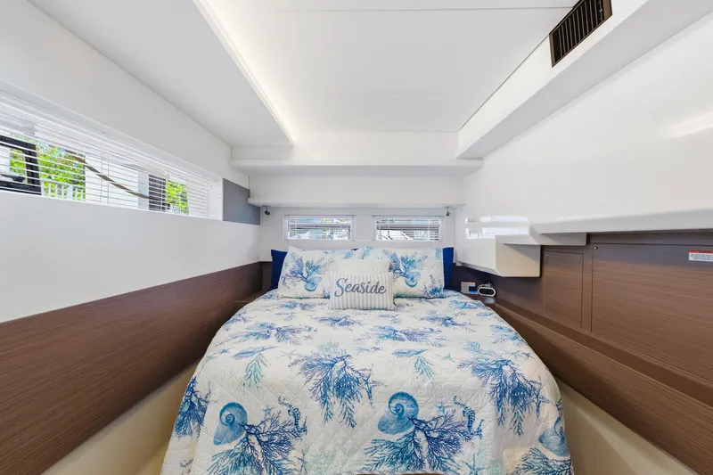 Better Now Yacht Photos Pics Luxurious bedroom interior of 2023 Leopard 46 Powercat with nautical-themed bedding.