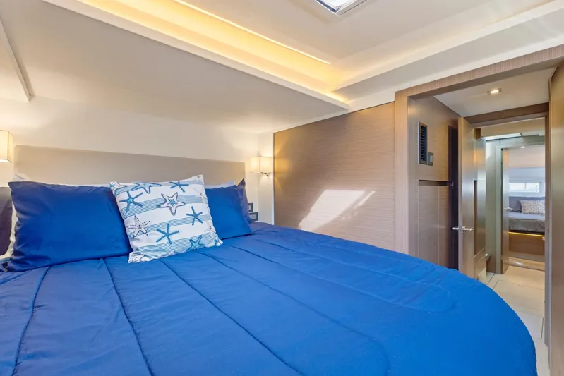 Better Now Yacht Photos Pics Luxurious bedroom interior of 2023 Leopard 46 Powercat with blue bedding and modern design.