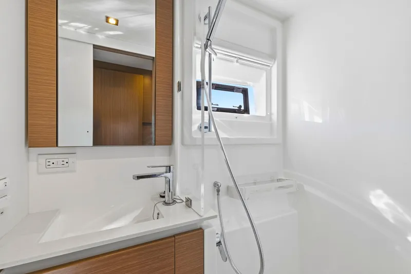 Better Now Yacht Photos Pics Modern bathroom in 2023 Leopard 46 Powercat yacht with sleek fixtures and window.