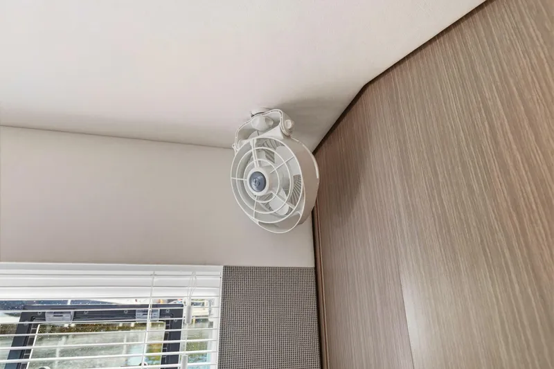 Better Now Yacht Photos Pics Ceiling fan in 2023 Leopard 46 Powercat interior, near window blinds and wood paneling.