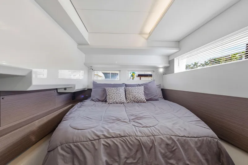 Better Now Yacht Photos Pics Luxurious bedroom interior of 2023 Leopard 46 Powercat yacht with modern design and cozy bedding.