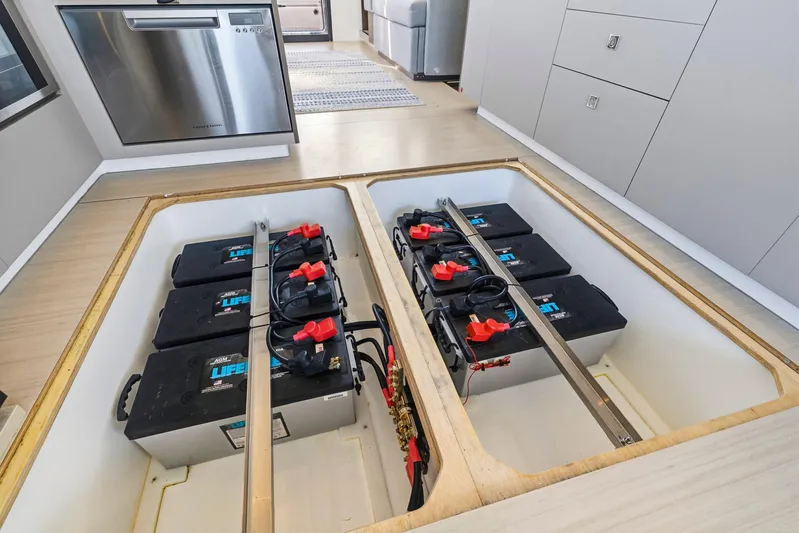 Better Now Yacht Photos Pics 2023 Leopard 46 Powercat battery compartment with multiple batteries and modern kitchen appliances.