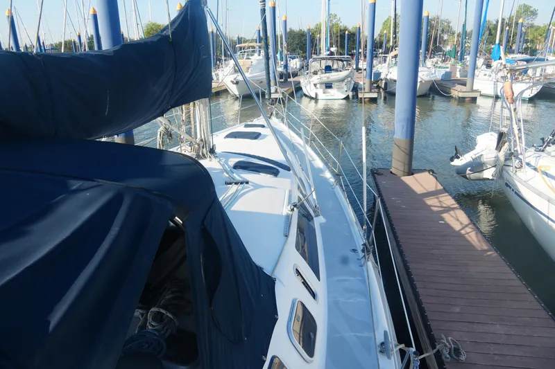 Andiamo Yacht Photos Pics 1998 Hunter 410 sailboat docked at marina, surrounded by other boats.