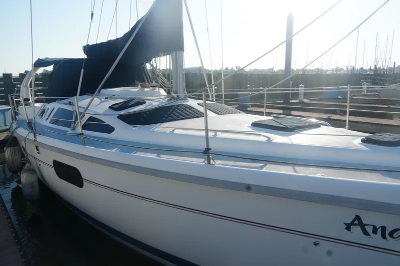 Andiamo Yacht Photos Pics Sailboat docked at marina, 1998 Hunter 410 model, white hull, blue cover.