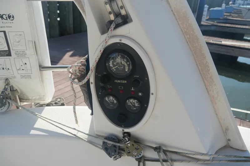 Andiamo Yacht Photos Pics Control panel of a 1998 Hunter 410 sailboat with gauges and ropes.