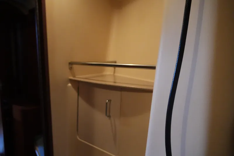 Andiamo Yacht Photos Pics Interior of 1998 Hunter 410 sailboat with storage cabinet and railing.