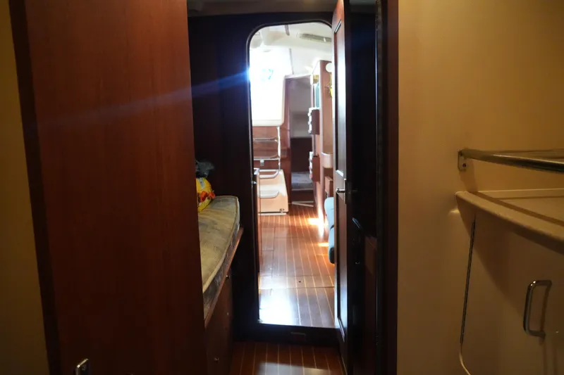 Andiamo Yacht Photos Pics Interior view of 1998 Hunter 410 sailboat cabin with wooden flooring and cozy layout.