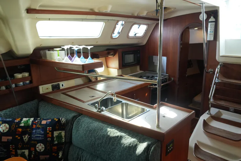 Andiamo Yacht Photos Pics Interior of 1998 Hunter 410 sailboat with kitchen and seating area.