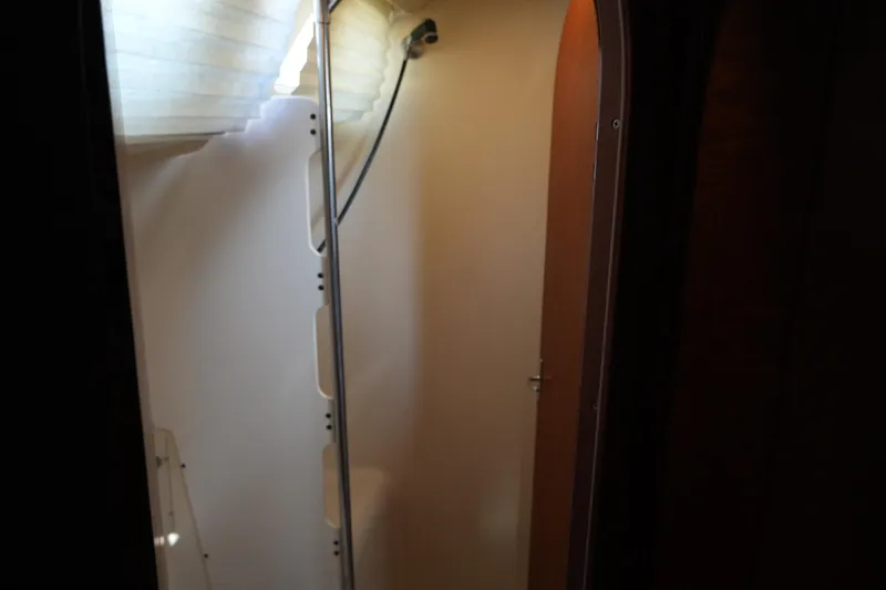 Andiamo Yacht Photos Pics Interior view of a 1998 Hunter 410 sailboat shower area with natural light.