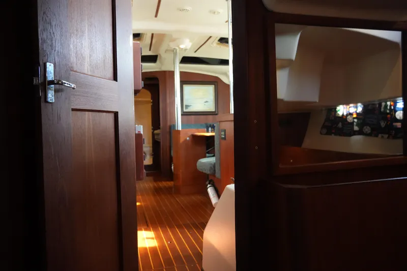Andiamo Yacht Photos Pics Interior view of 1998 Hunter 410 sailboat, featuring wooden finishes and cozy cabin space.