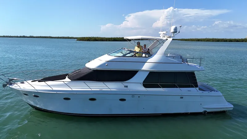 Bootlegger Yacht Photos Pics 1999 Carver 530 Voyager Pilothouse yacht cruising on calm waters.