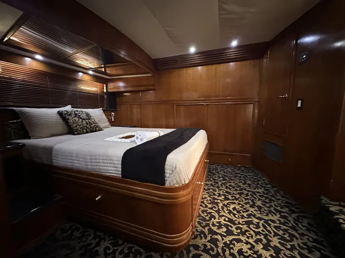 Bootlegger Yacht Photos Pics Luxurious bedroom interior of 1999 Carver 530 Voyager Pilothouse yacht with elegant wood finish.