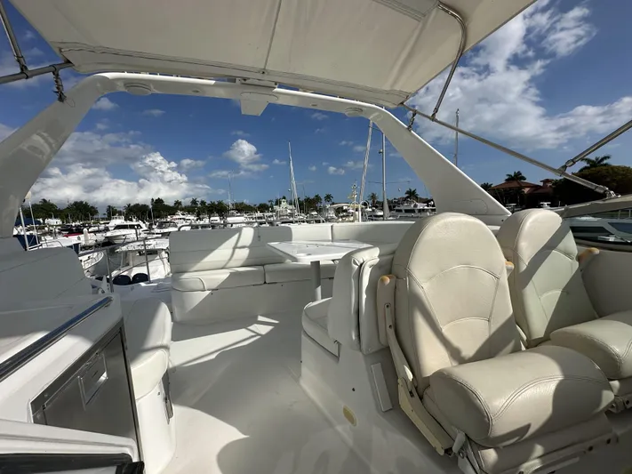 Bootlegger Yacht Photos Pics 1999 Carver 530 Voyager Pilothouse yacht interior with white seating and marina view.