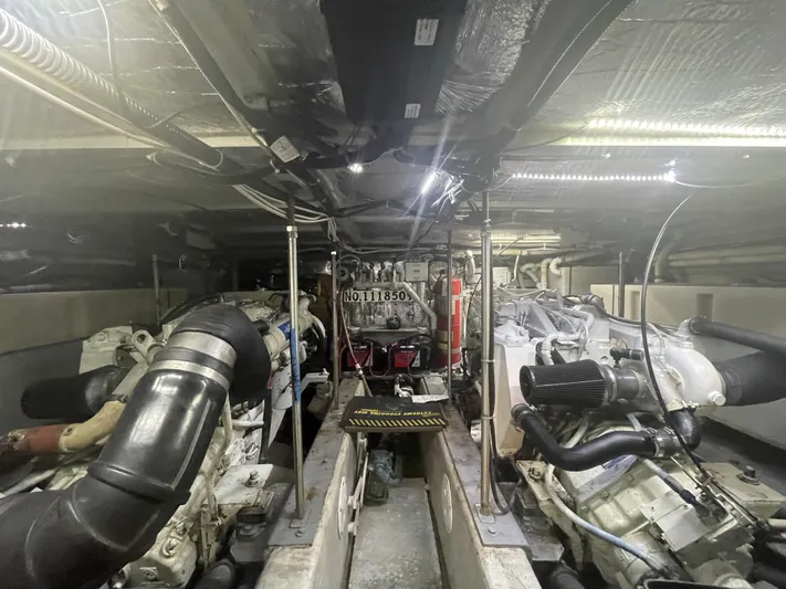 Bootlegger Yacht Photos Pics Engine room of a 1999 Carver 530 Voyager Pilothouse, showcasing mechanical components and systems.