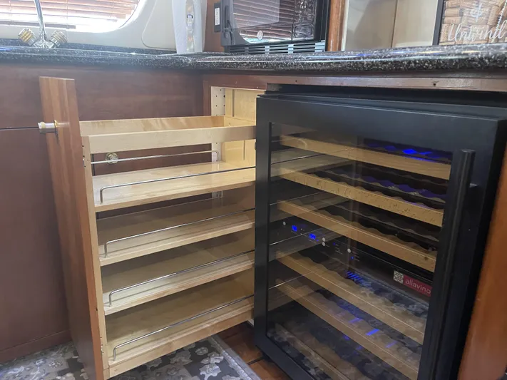 Bootlegger Yacht Photos Pics 1999 Carver 530 Voyager Pilothouse kitchen with wine cooler and pull-out shelves.