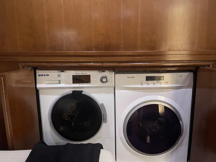 Bootlegger Yacht Photos Pics Laundry appliances in a 1999 Carver 530 Voyager Pilothouse, wooden cabinetry background.