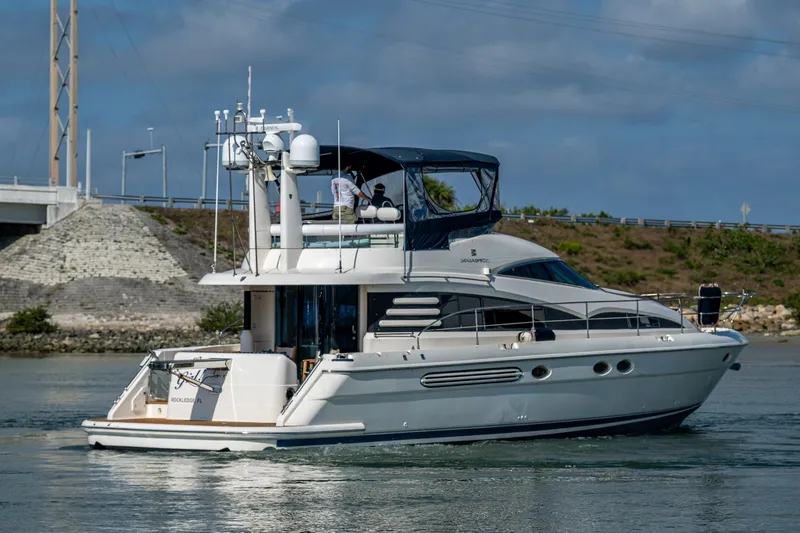 You Go Girl! Yacht Photos Pics 2000 Fairline Squadron 52 yacht cruising on a calm waterway under a blue sky.
