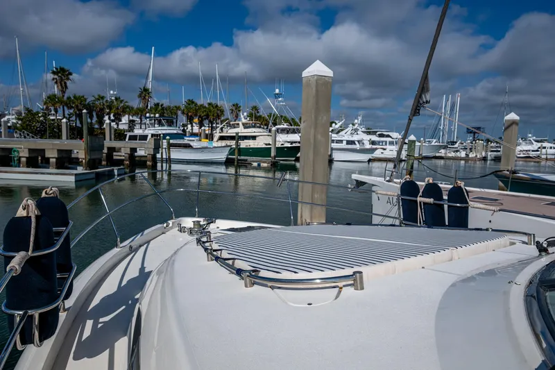 You Go Girl! Yacht Photos Pics Fairline Squadron 52 yacht docked in a marina, 2000 model, with clear skies and palm trees.