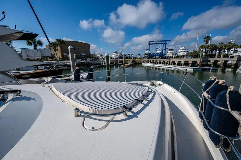 You Go Girl! Yacht Photos Pics Fairline Squadron 52 yacht deck, 2000 model, docked in a marina under a blue sky.