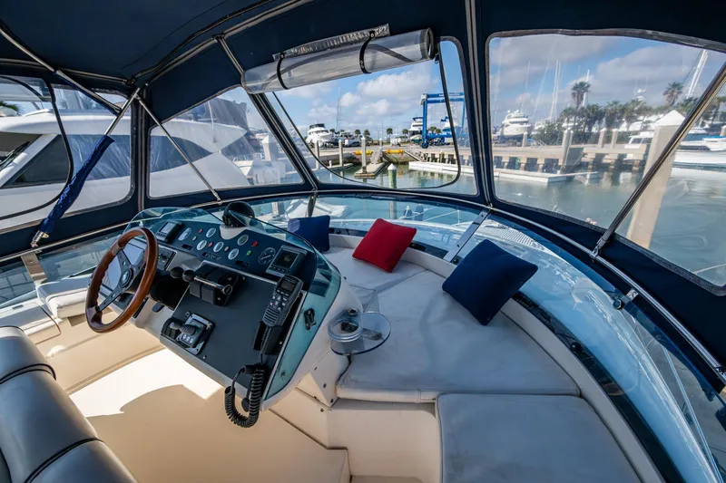 You Go Girl! Yacht Photos Pics Interior view of 2000 Fairline Squadron 52 yacht helm with marina backdrop.