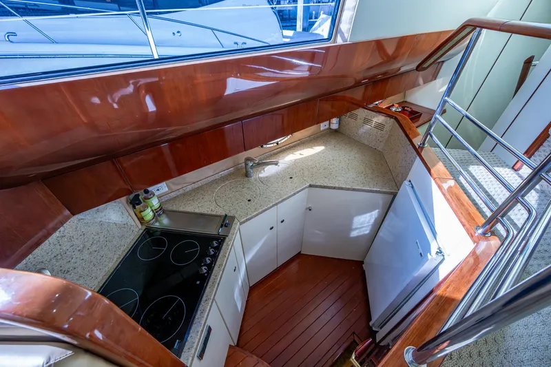 You Go Girl! Yacht Photos Pics Interior kitchen of 2000 Fairline Squadron 52 yacht with modern appliances and wood finish.
