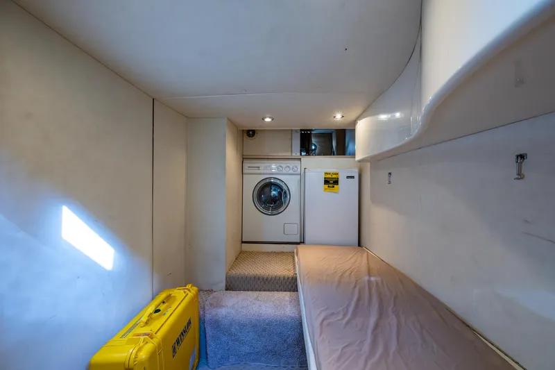 You Go Girl! Yacht Photos Pics Laundry room with washer, dryer, and storage in 2000 Fairline Squadron 52 yacht.