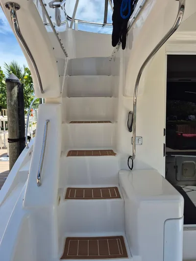 Freebyrd II Yacht Photos Pics Staircase on a 2002 Silverton 38 Convertible yacht, featuring sleek design and stainless steel railings.