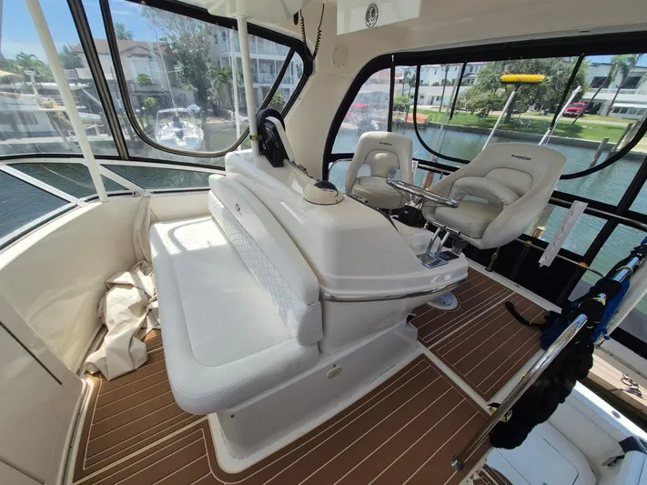 Freebyrd II Yacht Photos Pics Interior of a 2002 Silverton 38 Convertible yacht with helm and seating area.
