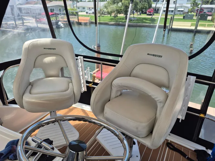Freebyrd II Yacht Photos Pics Captain's chairs on 2002 Silverton 38 Convertible yacht, overlooking marina.