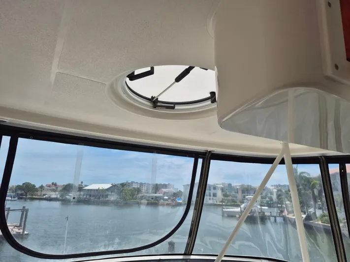 Freebyrd II Yacht Photos Pics Interior view from a 2002 Silverton 38 Convertible yacht, overlooking a marina.