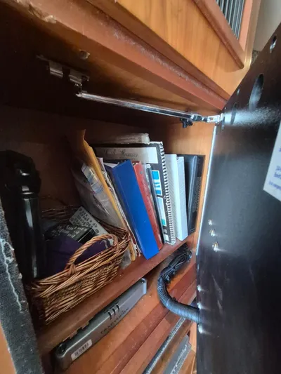 Freebyrd II Yacht Photos Pics Cabinet interior with books and basket on a 2002 Silverton 38 Convertible boat.