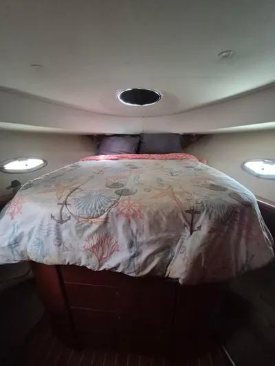 Freebyrd II Yacht Photos Pics Cozy bedroom in 2002 Silverton 38 Convertible yacht with nautical-themed bedding.