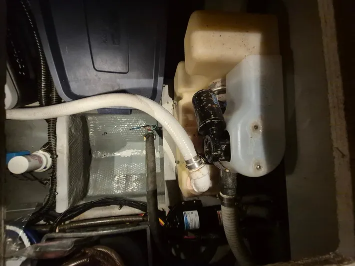 Freebyrd II Yacht Photos Pics Engine compartment of a 2002 Silverton 38 Convertible boat, showing hoses and components.