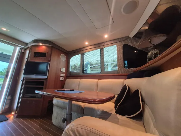 Freebyrd II Yacht Photos Pics Interior of 2002 Silverton 38 Convertible yacht with cozy seating and entertainment area.