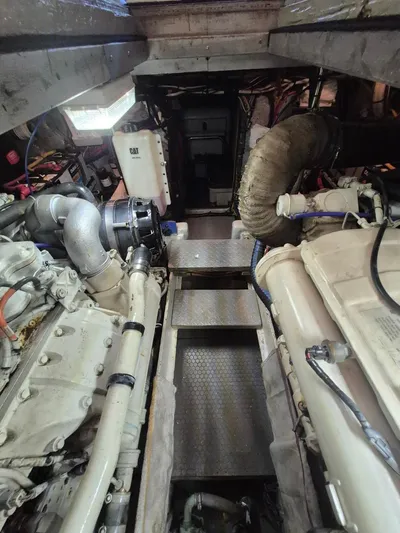 Freebyrd II Yacht Photos Pics Engine room of a 2002 Silverton 38 Convertible boat, featuring dual engines and mechanical components.