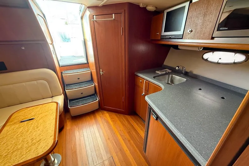  Yacht Photos Pics 2006 Tiara 3600 yacht interior with kitchenette, seating, and wooden flooring.
