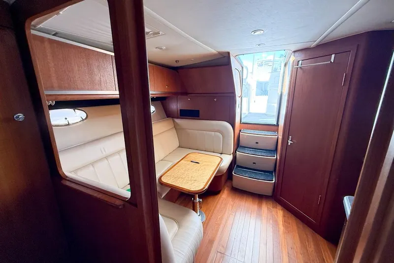  Yacht Photos Pics Luxurious interior of 2006 Tiara 3600 yacht with wood finish and leather seating.