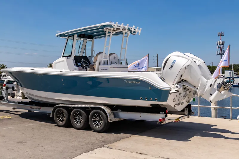  Yacht Photos Pics 2025 Edgewater 325CC boat on trailer, dockside, with twin Yamaha engines.