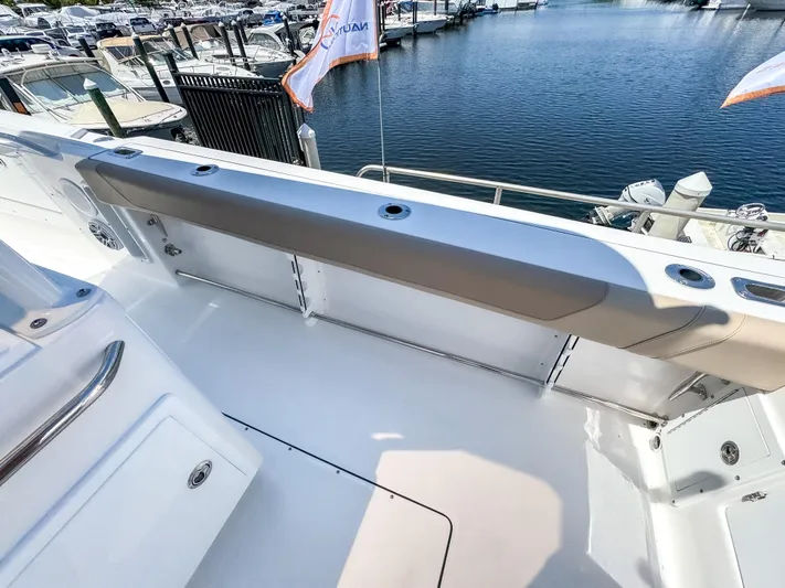  Yacht Photos Pics 2025 Edgewater 325CC boat deck with seating, docked at marina.