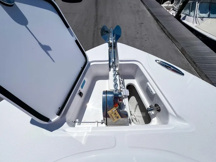  Yacht Photos Pics 2025 Edgewater 325CC boat anchor compartment with open hatch and chain mechanism.