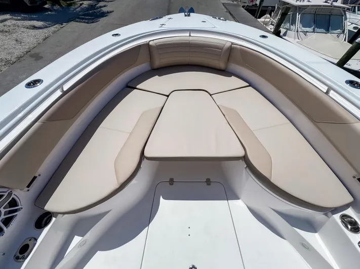  Yacht Photos Pics 2025 Edgewater 325CC boat with spacious, cushioned seating area in the bow.