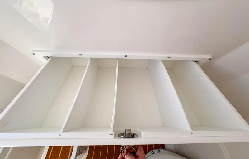 Yacht Photos Pics White storage compartment with dividers in 2025 Edgewater 325CC boat interior.