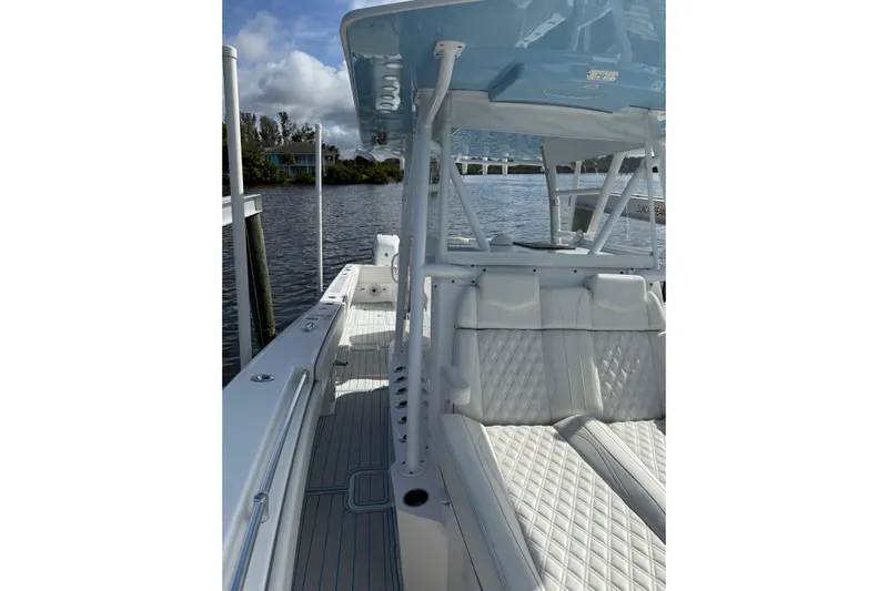  Yacht Photos Pics 2021 Invincible 36 CC boat with white seating and sleek design on a calm waterway.