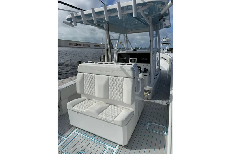  Yacht Photos Pics 2021 Invincible 36 CC boat interior with white seating and modern dashboard.