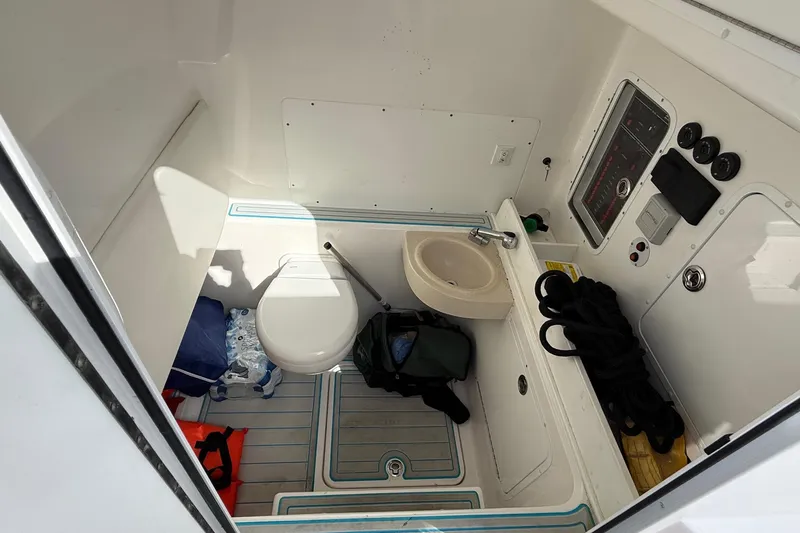  Yacht Photos Pics 2021 Invincible 36 CC boat interior with toilet, sink, and storage area.