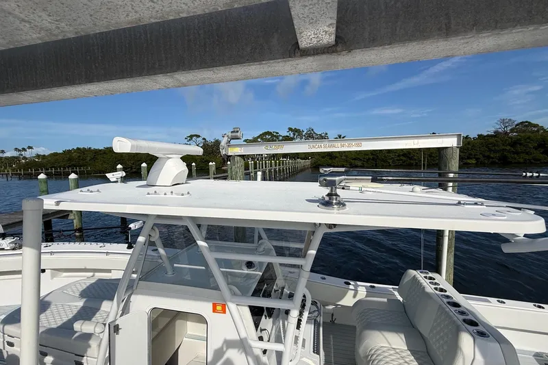  Yacht Photos Pics 2021 Invincible 36 CC boat docked, featuring sleek design and spacious seating.