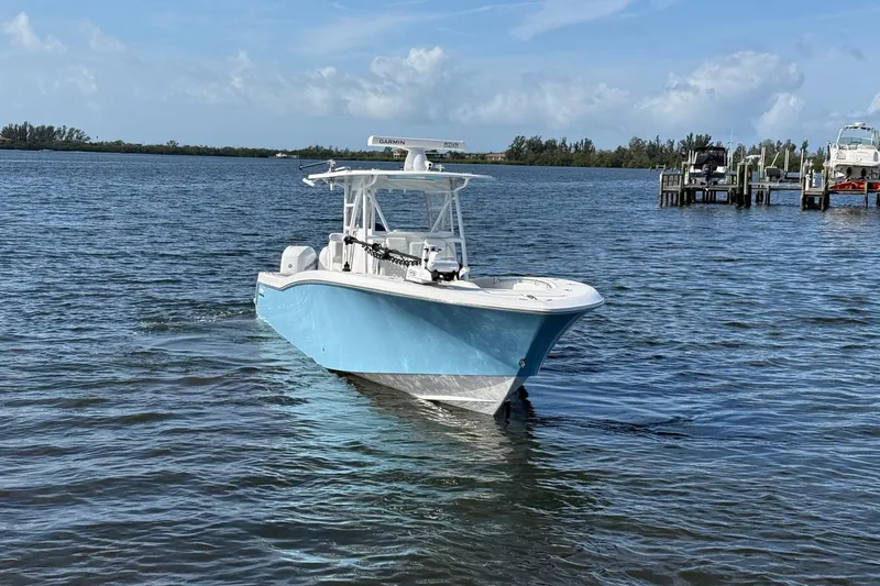  Yacht Photos Pics 2021 Invincible 36 CC boat on calm water, clear sky background.